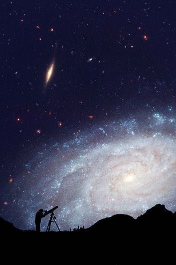 An astronomer looks at the night sky through a telescope.