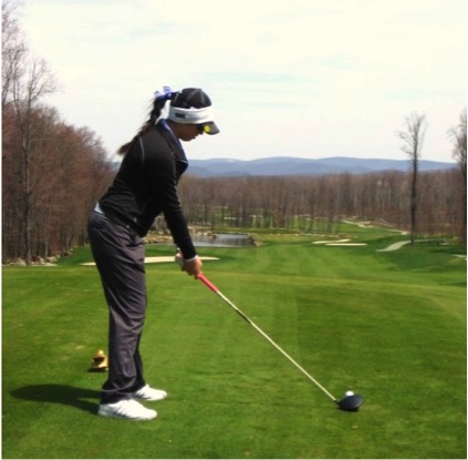 Junior Lena Capoccia hits a tee shot.
