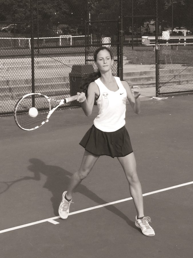 Sopomore Sofia Hahn hits the ball during a tennis match. The girls tennis team placed second at counties and credits their success to hard work at practice and strong leadership from their captains.