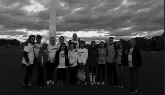 Umttr members and other students walking with Baker at the event.