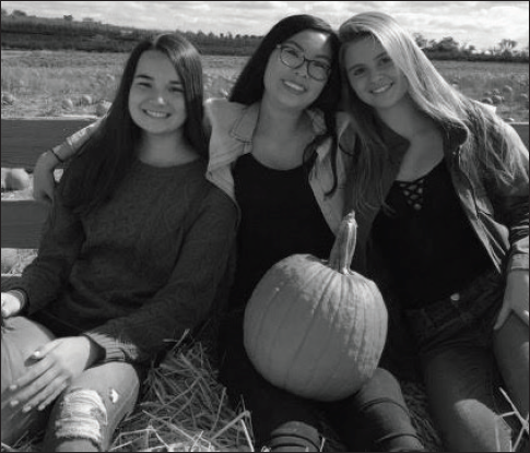 Sophomores Jetta Chen, Rebecca Hu and Caroline Wallerstedt take a hayride to the pumpkin patch at Homestead Farm. In the fall, Homestead Farm also offers several varieties of apples.