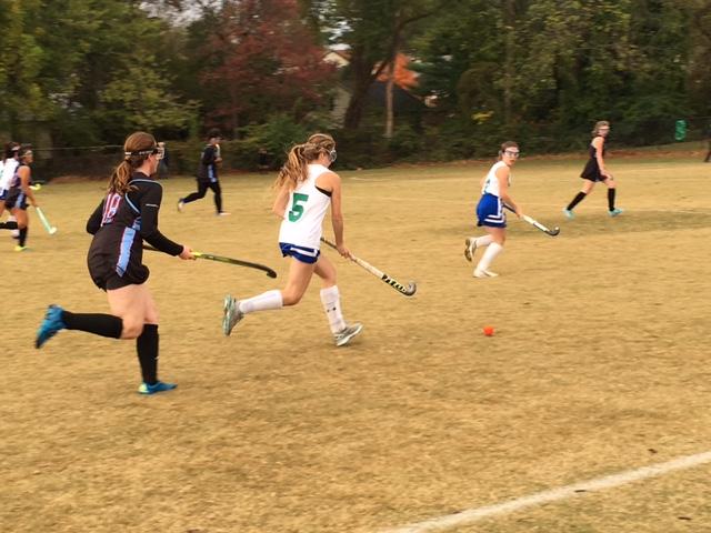 Sophomore Regan Solomon (#5) chases after the ball while being trailed by a defender. The Bulldogs were 16-0 in the regular season.