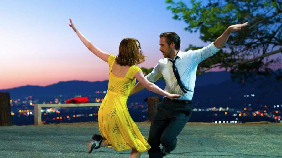 Mia and Sebastian in a scene from La La Land with a beautiful sunset in the background.