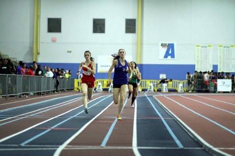 Senior Gwen Asbury sprints down the track during an indoor track meet.