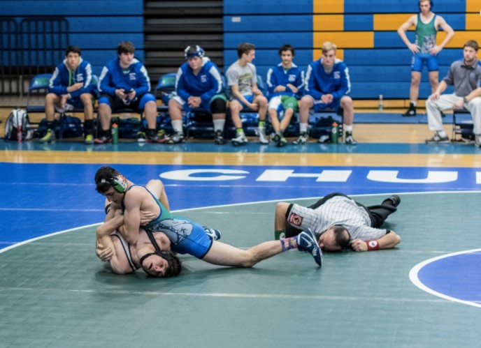 Junior Jack Connolly wrestles an opponent to the ground. Connolly was named “outstanding
wrestler” in a tournament againt Paint Branch.