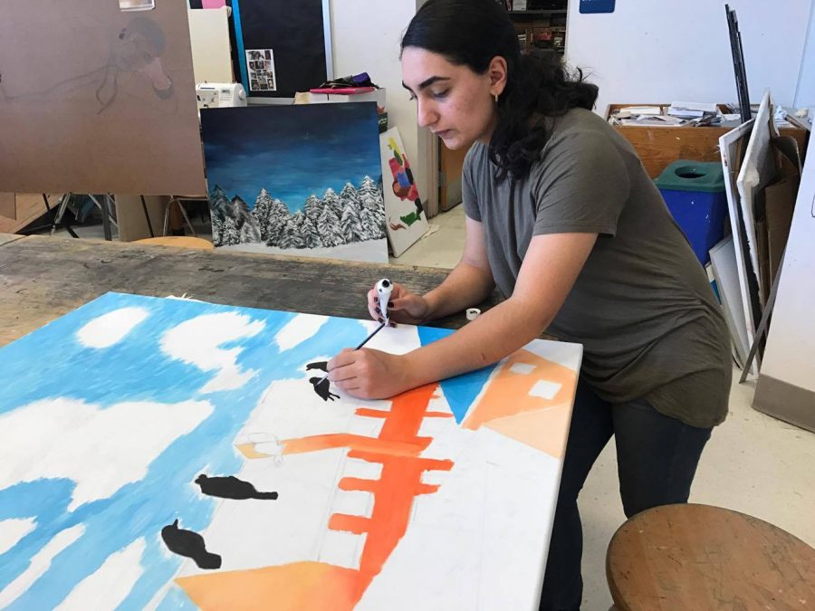 Senior Laudan Nikoobakht paints birds sitting on a wire for this year’s Youth Art for Healing project.