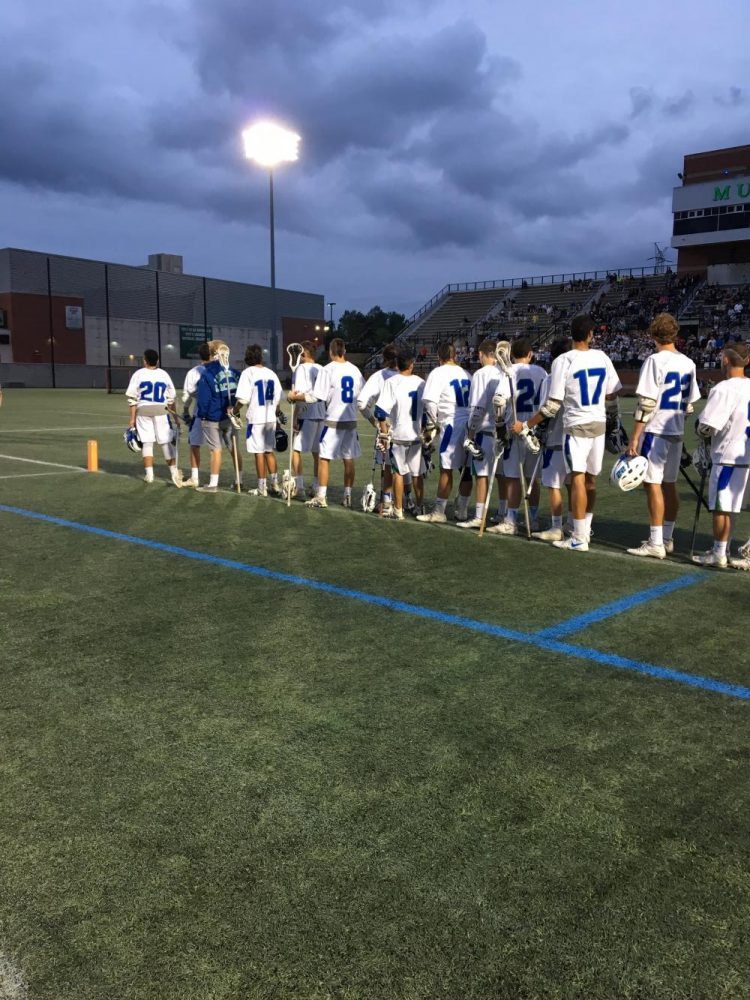 The CHS Lacrosse team stands for the national anthem ahead of the state championship game.
