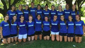 The 2017 Girl's Varsity Soccer Team poses for a group photo outside the field.