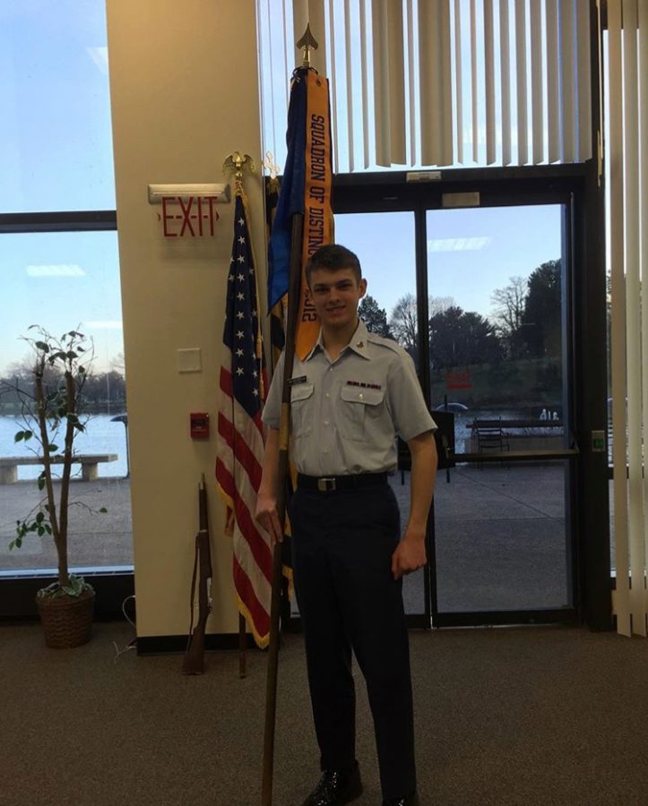 Senior Patrick Cousins holds his squadron's flag.