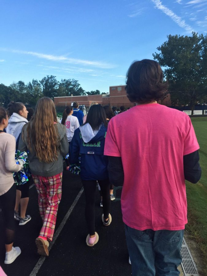 CHS students, including Varsity Cheer and the drumline walk around the track to raise Breast Cancer Awareness.