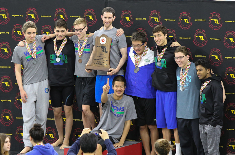 Coach Tappis stands with the boys team after winning the metros competition. 