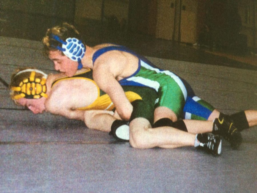 WCHS 2002 alumnus David Kraus pins his opponent during a wrestling meet. 
