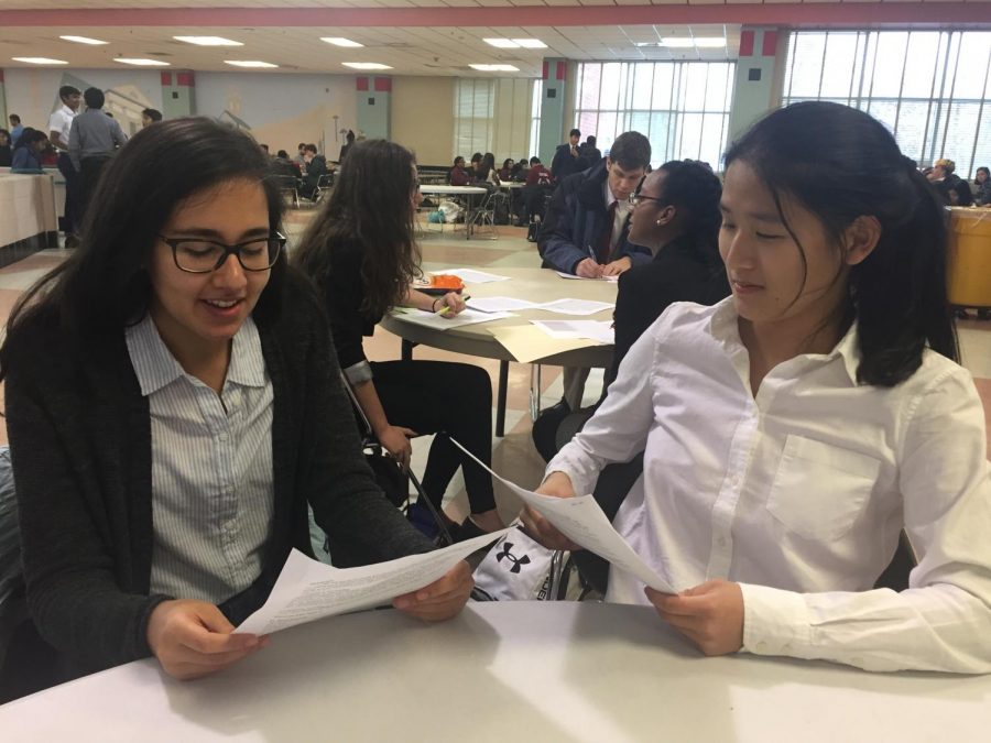 Sophomore Emily Tong and senior Janneke Kovoor practice their speaking points and plan their arguement at the Dec. 12 debate tournament at Blair High School.