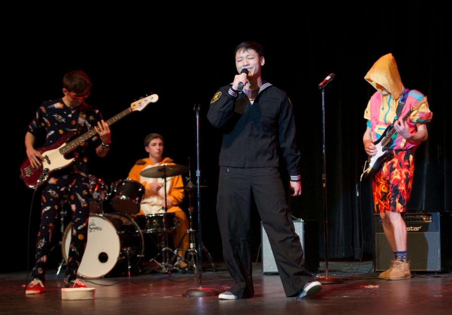 Tam, center, accompanies his band, Ethiopian Death Jazz, on stage.