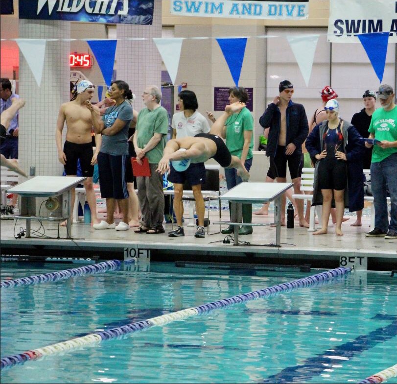 John Nguyen explodes off the blocks as he begins to swim.
