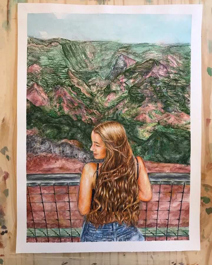 Elizabeth Kronthals self portrait with a background of a cluster of mountains. 