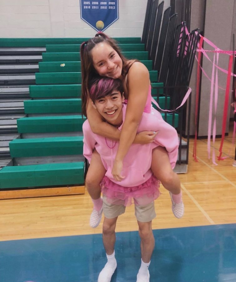Haley Gye and Aiden Sung smile as they model bright pink to raise awareness about the Dig Pink game and the cause.