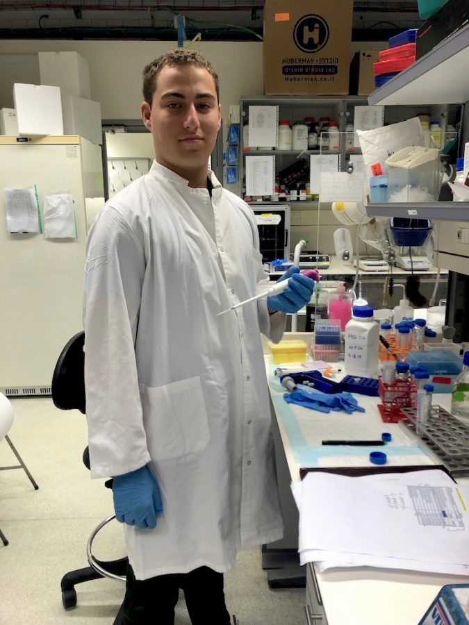 Dressed up in his white lab coat and blue gloves, Nathan Slotnik makes the most of his SciTech Scholarship as he holds a micropipette in the laboratory, ready to contribute to finding a cure for Duchenne muscular dystrophy.
