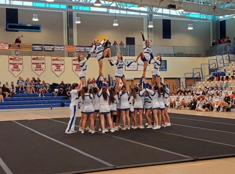 The WCHS cheer team stunts at the MCPS regional competition. The team has been practicing these elaborate tricks all season.