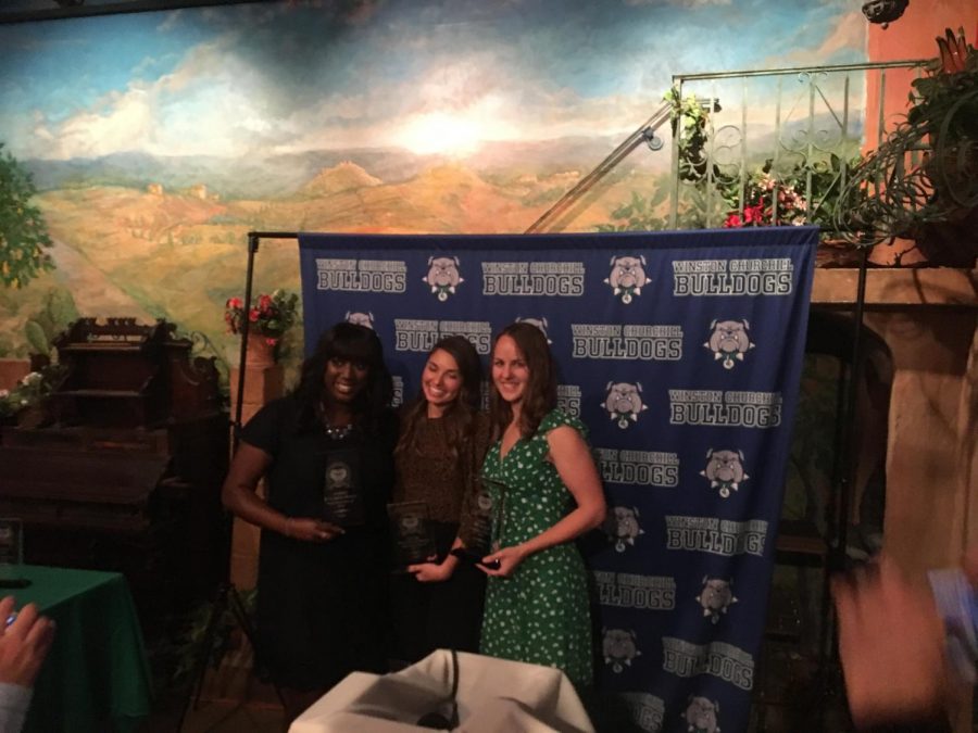 Former track student-athletes (left to right) Audrey M. Gariepy-Bogui, Louise Hannallah Bayly and Erin McManus pose together with their Athletics Hall of Fame trophies.