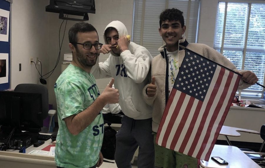 Mr. Rosenthal, David Miskin, and Jay Wood pose with an American flag in spirit of USA day. 