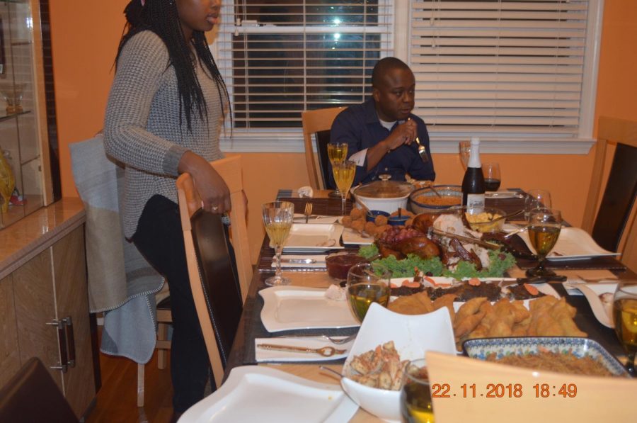 The dining table is set fora typical Thanksgiving dinner.