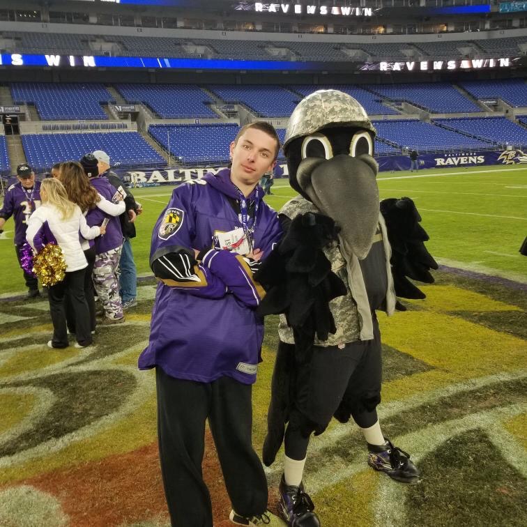 Robinson poses alongside Baltimore Ravens mascot, Poe, during his postgame experience at M&T Bank Stadium.