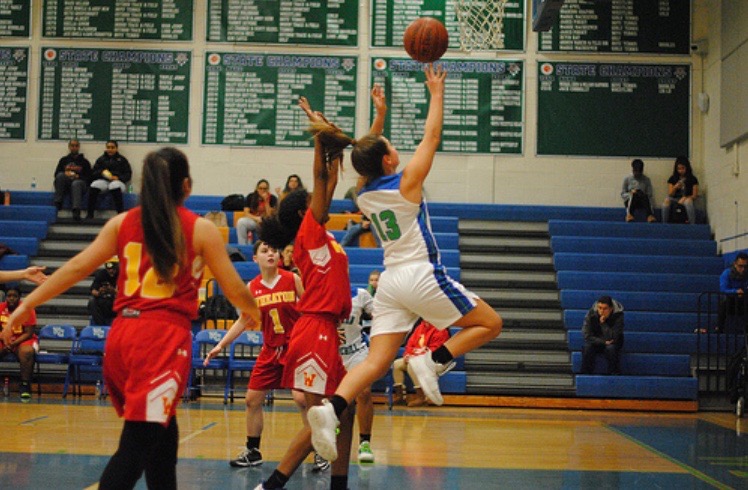 Senior Katie Stanish shoots a lay-up in a game against Wheaton. This is her fourth year on varisty basketball and she is excited for the 2019-2020 season.