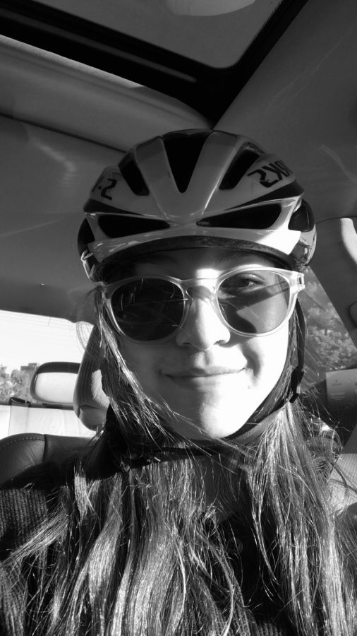  Stephanie Zoltick wears her helmet before a bike ride. Zoltick prioritizes safety and knows the consequences of riding without a helmet.