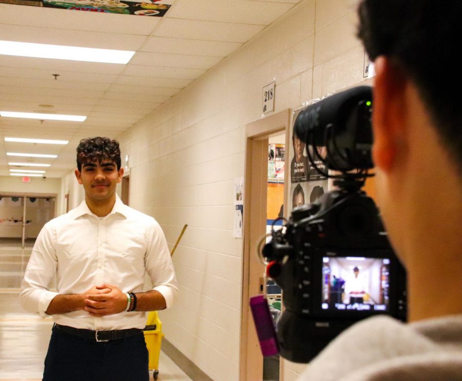 WCHS President Jay Wood preparing to speak for his SMOB announcement video in the halls of WCHS.