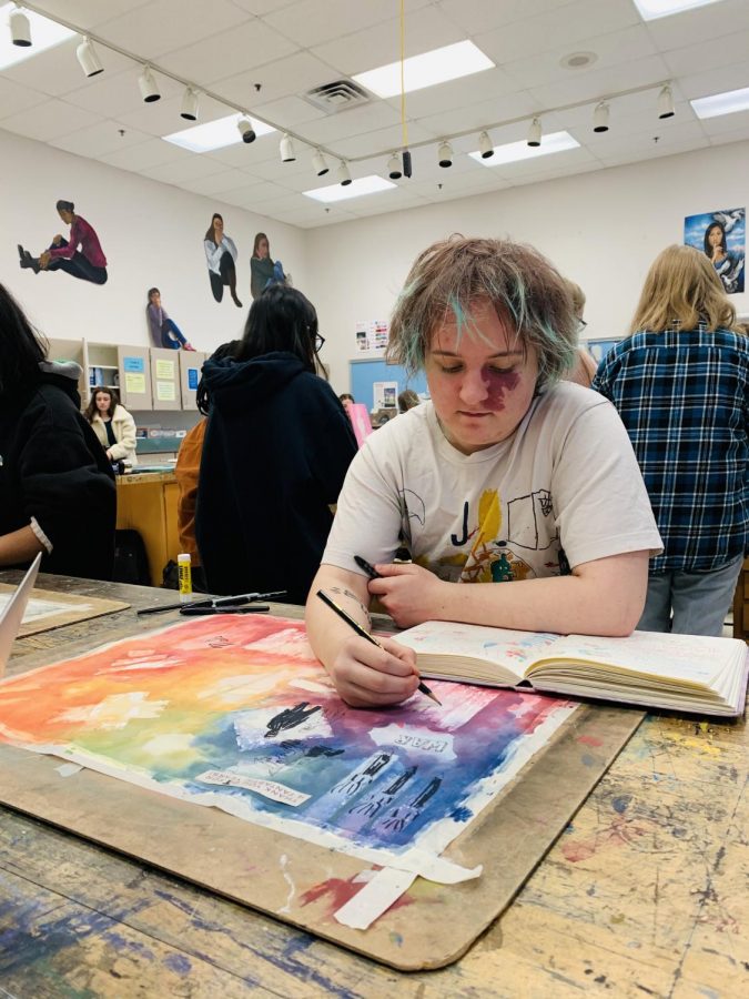 WCHS senior Markus Silvertree paints in his 4th period class, AP Art Studio, for his sustained investigation. On this large sheet, a compilation of ideas for new and potential pieces are mixed into one consolidated and designed brainstorming board. 