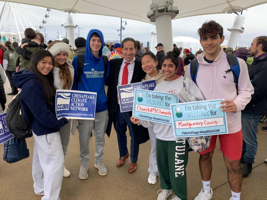 Churchill+for+Climate+members+smile+with+representative+Jamie+Raskin%2C+as+they+hold+posters+with+reasons+as+to+why+they+participated+in+the+polar+plunge