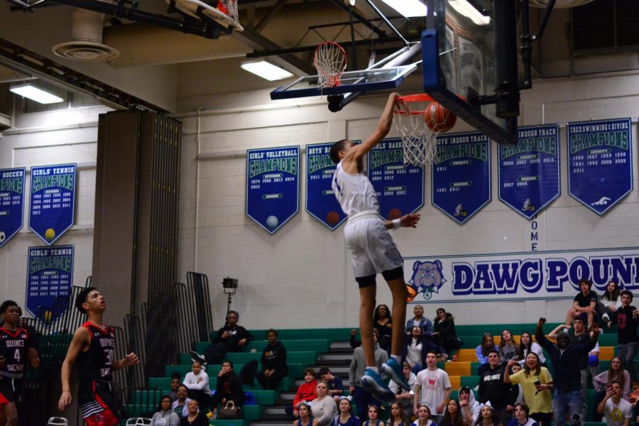 Senior Jomo Goings goes for a dunk during a game against Quince Orchard. The boys basketball team is looking for a long run in their seasons playoffs.