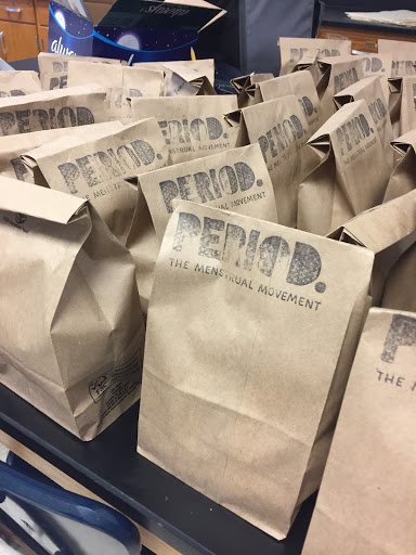 Donations from the period club sit on a table. The club tries to donate period products to women in need.