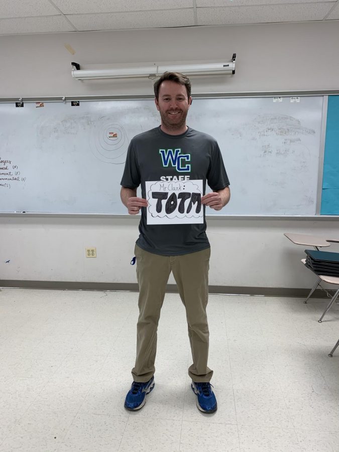 Mr. Clark poses for a photo with his award. The government teacher graduated from the University of Maryland with a double degree.