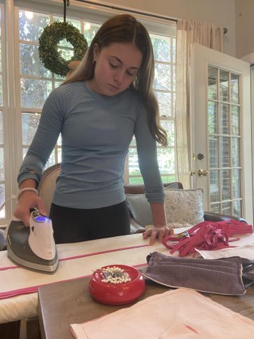 WCHS junior Cat Gilligan irons fabric that she will later sew to make face masks for those who need them during the pandemic. With the help of WCHS students and families, Gilligan has been able to craft and donate many masks to patients at local hospitals that are unable to get them on their own.