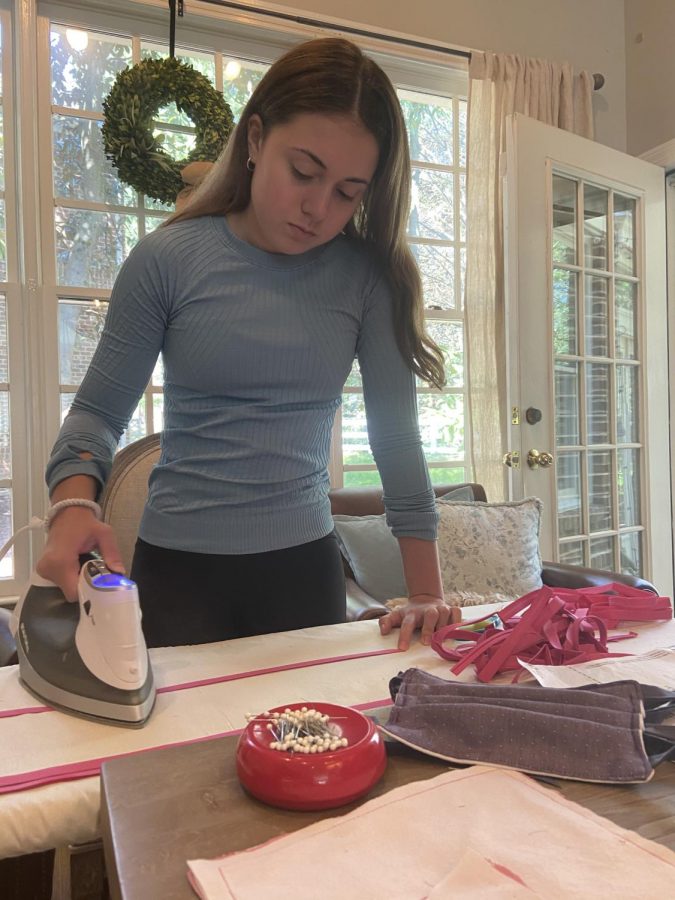 WCHS junior Cat Gilligan irons fabric that she will later sew to make face masks for those who need them during the pandemic. With the help of WCHS students and families, Gilligan has been able to craft and donate many masks to patients at local hospitals that are unable to get them on their own. 