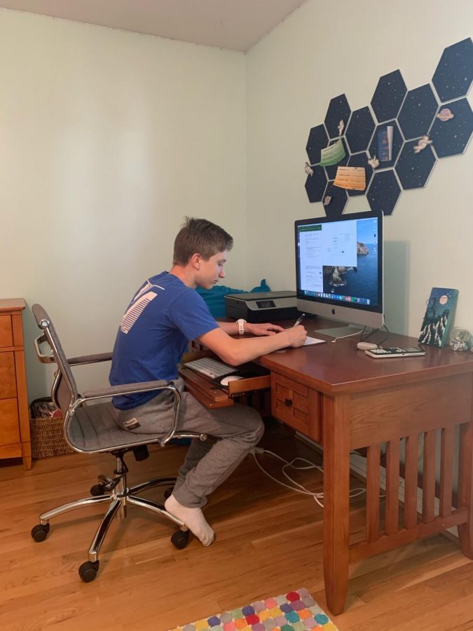 Josh Heimlich sits at his workspace in his house after a day of online school and works on his new assignments.  “I enjoy having the freedom to choose where I want to work based on how productive I will be,” said Josh.  Josh has been working in this office for the past few months because he has been productive here.

