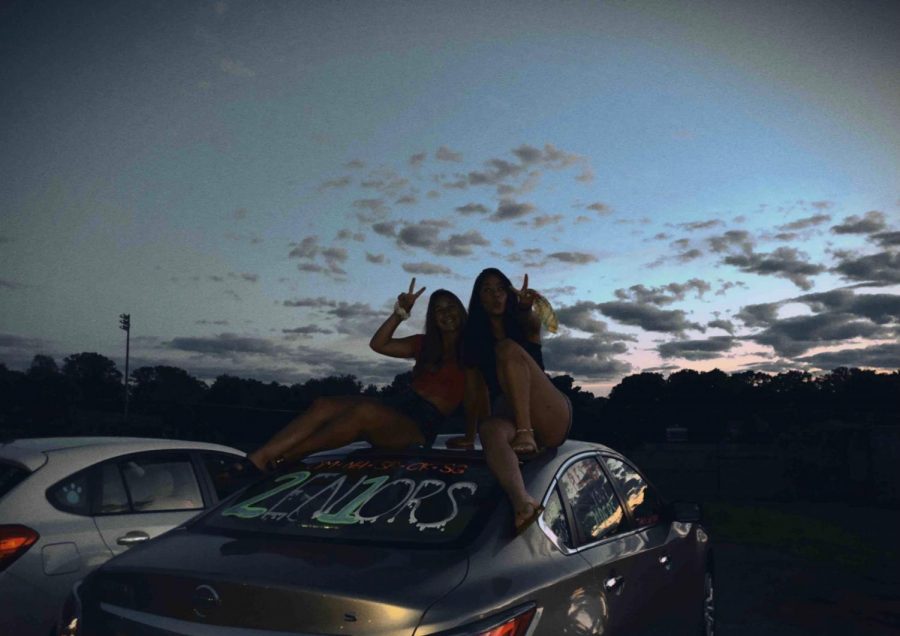 Olivia Meshanko and Natalie Heshmat pose on top of a newly decorated car. Shoshana Rosenthal has been using an app that emulates a disposable cameras in order to make lasting memories with her friends.