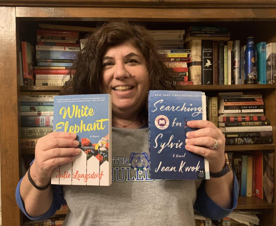 Deli poses with the 2 books she got in the mail. A book lover who owns over a hundred books, she was super excited to receive and read books she does not own yet.