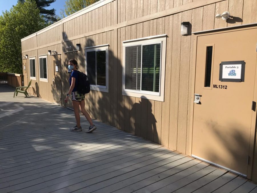 At+WCHS%2C+sophomore+Sydney+Willich+walks+to+her+class+in+Portable+3.+Portables+are+a+new+addition+to+WCHS+this+year+to+accommodate+all+students.+