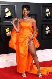 Megan thee Stallion smiles for the cameras on the red carpet as her photo is taken. She swept the Grammys this year, winning 3 awards.