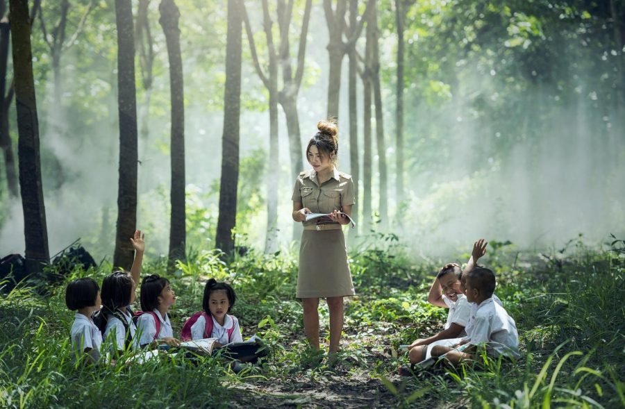 A teacher and her students adjust to outdoor learning environment. WCHS plans to implement the same idea to improve academic performance.