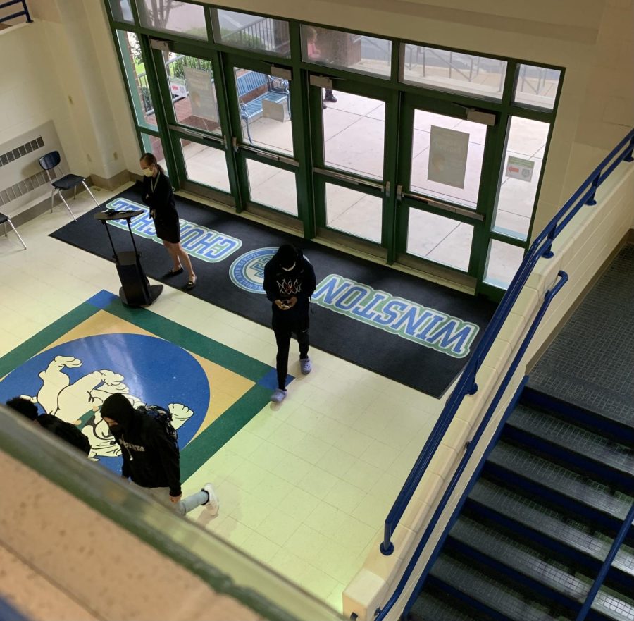 A WCHS staff member monitors the front doors by the Bulldog Lobby out into the bus loop to make sure that only seniors who show their lunch passes are eligible to leave at lunch. 