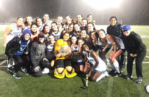 Smiling for the camera, the WCHS field hockey team proudly holds up the plaque for winning the county championship game.