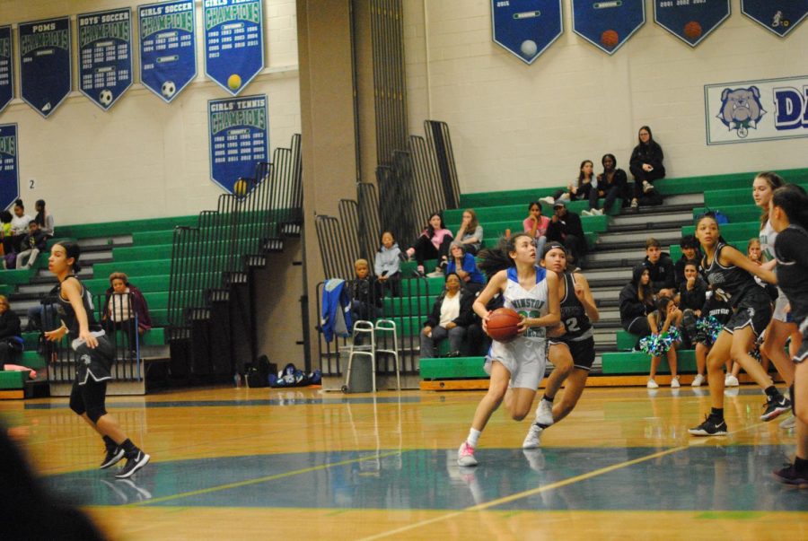 Dillan George, a junior on the basketball team, scoring a basket during a game pre-COVID. The conditions while playing will be relatively similar for the upcoming season. Players are not required to wear a mask during games and will be able to play much like they have in years past.