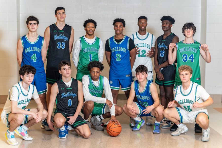 The boys basketball team poses together on media day in their four different sets of jersey colors. 