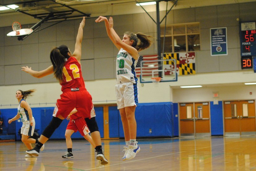 Shooting guard Irene Haramis shoots a three-pointer during her freshman season. Despite not on court this season due to injury, Haramis looks forward to playing again at Dickinson College. 