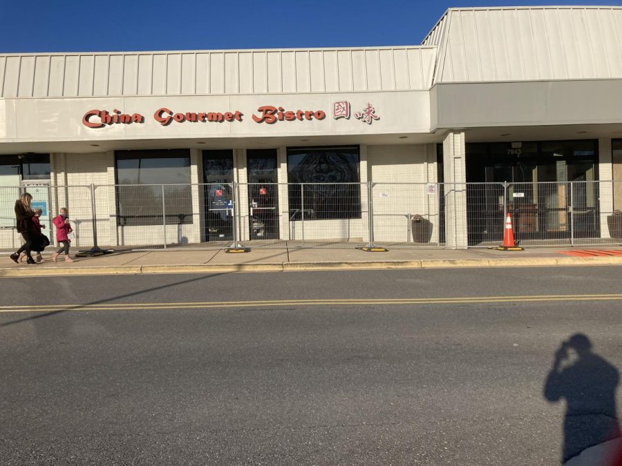 Metal grating separates the sidewalk and pedestrians from closed establishments between CVS and Giant -- including China Gourmet Bistro, Breadsmith, Capital One Bank and the Grilled Oyster Company -- that will eventually be cleared to make way for a road separating the convenience and grocery stores. 