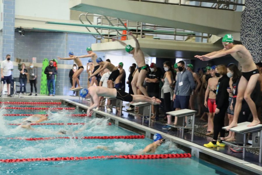 The+swim+team+competes+in+a+relay+race+in+which+they+won+against+WJ.+On+Feb.+12+the+team+upset+Gonzaga+to+take+home+the+Metro+Championship.